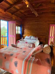 a bedroom with two beds in a log cabin at Hotel Areca in Murillo +83 photos