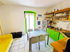 a kitchen with green cabinets and a table and chairs at Croparadise Central in Split