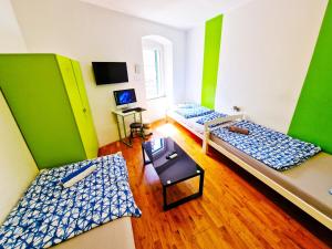 two beds in a room with green and white at Croparadise Central in Split
