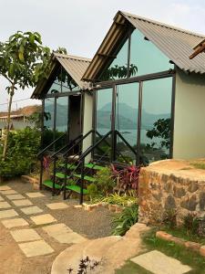 a house with a view of the mountains at Shelby Pawana lake Cottages and Camping in Lonavala
