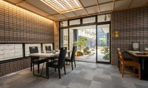 a dining room with a table and chairs at 心斎橋難波関空直通 Ambers Hostel in Osaka