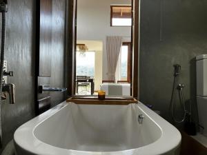 a large white bath tub in a bathroom at SereneVbes - Kandy in Kandy