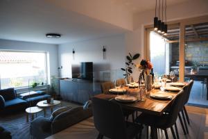 a dining table and chairs in a living room at Villa Leo in Koper