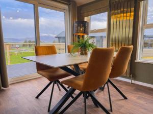 a dining room with a table and four chairs at Honeysuckle Lodge in Bassenthwaite