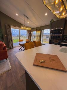 a kitchen with a table with a cutting board on it at Honeysuckle Lodge in Bassenthwaite