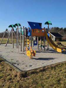 a playground with a slide in a park at Riis Feriepark in Give