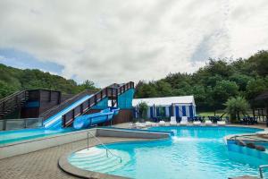 a large swimming pool with a water slide at Riis Feriepark in Give