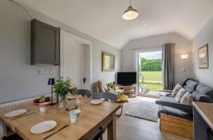 a living room with a table and a couch at The Warren in Biddenden