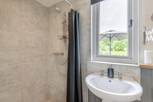 a bathroom with a sink and a window at The Warren in Biddenden +27 photos