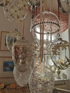 a group of glass vases hanging from a chandelier at Maisonette "im Alten Pfarrhaus" in Neuruppin +8 photos