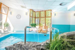 a pool in a house with a swimming pool at Relax hotel FIM in Belá +26 photos