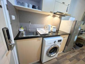 a kitchen with a sink and a washing machine at My Resort Condo in Hua Hin E204 in Hua Hin