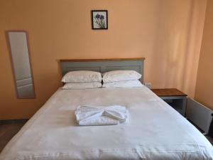 a bed with two towels sitting on top of it at Bataung Guest House in Mafeteng