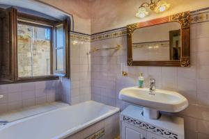 a bathroom with a sink and a tub and a mirror at Balco de l' Empordà in Corçà +17 photos