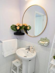 a white bathroom with a sink and a mirror at One bedroom,central location Wifi&Ac in Cancino