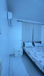 a bedroom with a bed with a blue light at درة عبين الجناح الخاص in ‘Ibbīn +10 photos