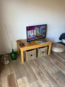a television sitting on a table in a living room at Casa das Oliveirinhas in Alvor