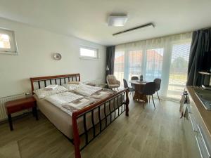 a bedroom with a bed and a table and chairs at Apartmán Mašovice u Znojma in Mašovice