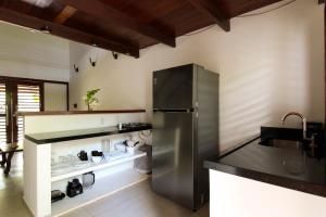 a kitchen with a stainless steel refrigerator at Vila Loop in São Miguel do Gostoso