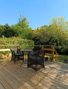 a wooden deck with a table and chairs on it at Skøn rolig villa in Dianalund