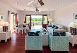 a living room with a couch and chairs and a table at Breathtaking Views Private 1 Bed Villa in Freetown Village