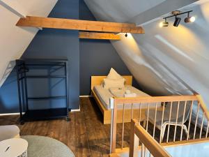 a bed in a room with a blue wall at Metropol Apartments & Suites in Tübingen