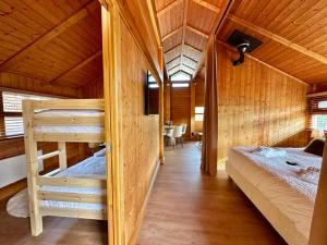 a bedroom with two bunk beds in a cabin at Chalet Ivoire in Durbuy
