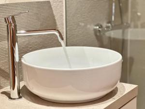a white sink with a faucet on a counter at Chalet Ivoire in Durbuy +13 photos