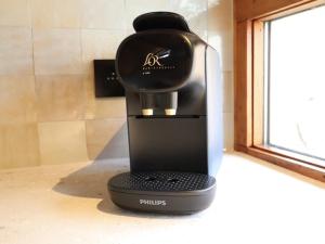 a coffee maker sitting on a counter next to a window at Chalet Ivoire in Durbuy