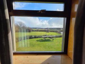 a view of a picnic table through a window at Peedie Sea Accommodation in Orkney