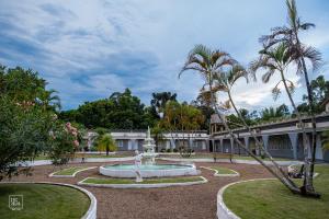 a courtyard with a fountain in front of a building at Hotel Premier in Santa Rita