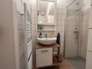a bathroom with a sink and a shower at Ferienwohnung MEERWEH in Fehmarn +14 photos