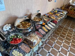 a buffet line with many different types of food at Hotel B&S Samarkand Boutique in Samarkand