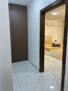 a room with a mirror and a bedroom with a bed at درة عبين الدور الارضي 2 in ‘Ibbīn +6 photos