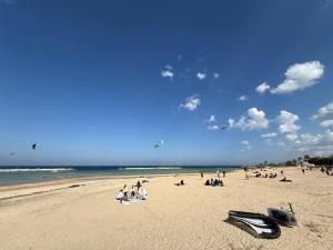 a group of people sitting on a beach at Rainbow Luxury Home Bari in Bari