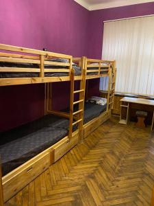a room with two bunk beds and a table at Хостел Центр in Kharkiv