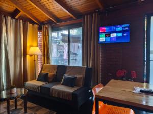 a living room with a couch and a table at Departamento BenLu in Puerto Iguazú