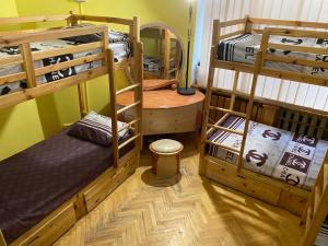 a room with two bunk beds and a desk at Хостел Центр in Kharkiv