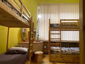 a bedroom with two bunk beds and a mirror at Хостел Центр in Kharkiv