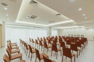 an empty room with rows of chairs in it at Hotel ORJEN sport & pleasure in Trebinje +110 photos