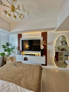 a bedroom with a bed and a tv and a mirror at Azure Luxe Haven by Irene in San Fernando +43 photos