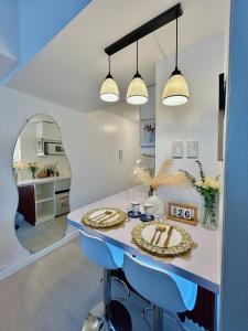 a dining room with a table and a mirror at Azure Luxe Haven by Irene in San Fernando