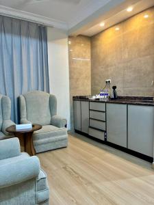 a waiting room with two chairs and a counter at BAIT AL-AFIA Hotel in Sur