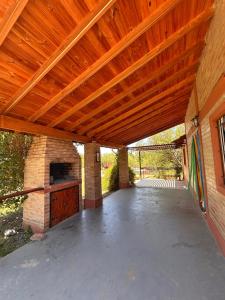 an outdoor patio with a wooden pergola at Malenka in Pantanillo