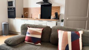 a living room with a couch with two pillows at Escapade sur la Loire in Nevers