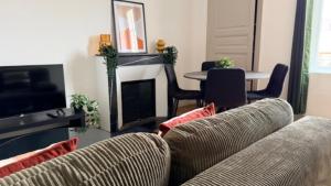 a living room with a couch and a fireplace at Escapade sur la Loire in Nevers