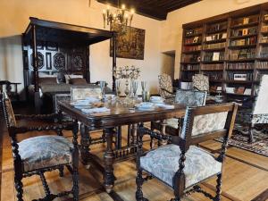 a dining room with a wooden table and chairs at Château de Saint Maurice in La Peyrouse