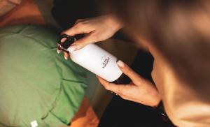 a person holding a white cup in their hands at Hotell Borgholm in Borgholm