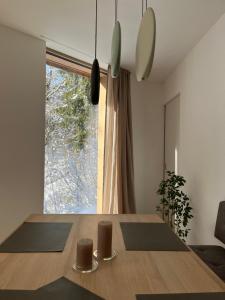 a dining room with a wooden table and a window at The Mountain Nest in Russbach am Pass Gschütt