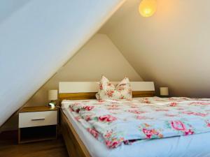 a bedroom with a bed with flowers on it at Ferienwohnung Storchennest Vipperow in Ludorf